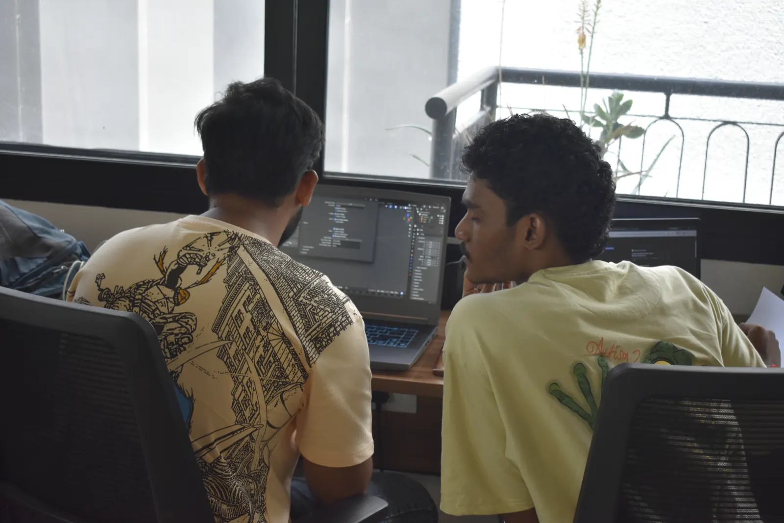 Two teammates working at one desk