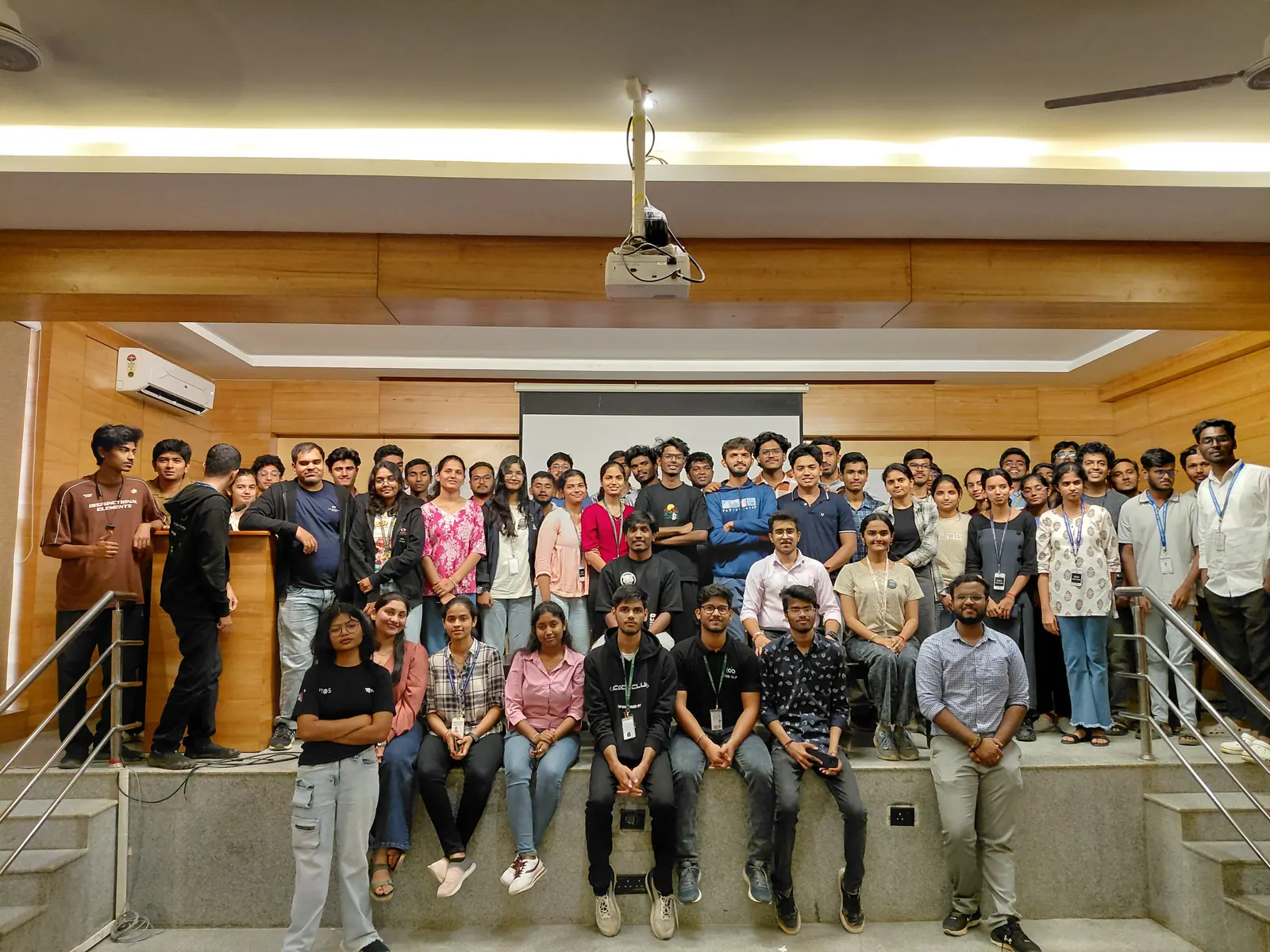A big group photo on a staircase after an event