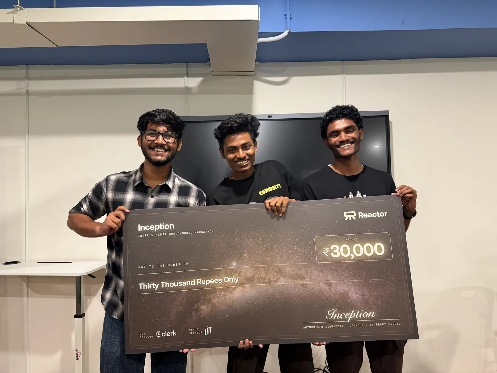 The team holding the Inception winner's cheque
