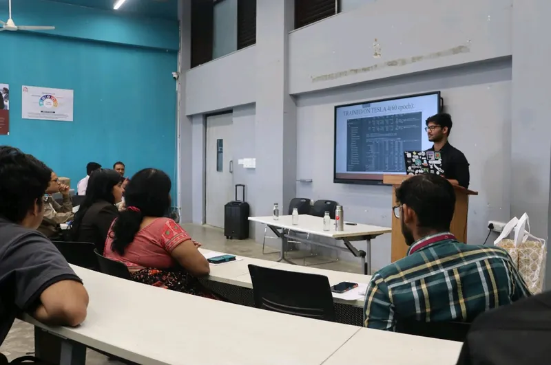 Ujesh presenting model-training results to a room
